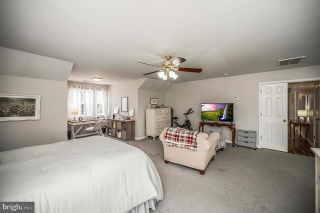 carpeted bedroom featuring vaulted ceiling, ceiling fan, and visible vents