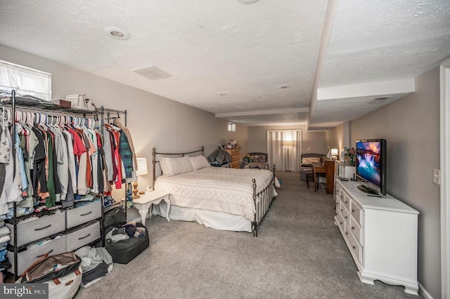 bedroom featuring a textured ceiling and carpet