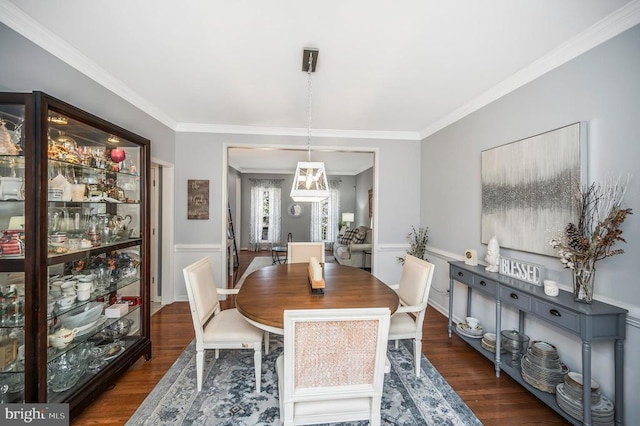 dining space featuring dark wood-type flooring and ornamental molding