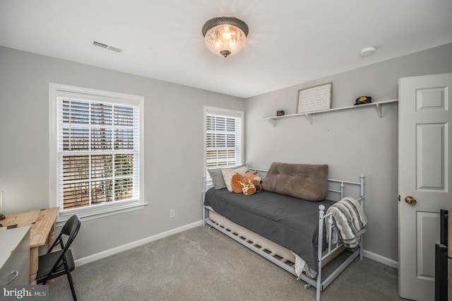 carpeted bedroom featuring baseboards and visible vents