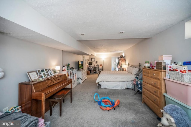 bedroom with a textured ceiling and carpet