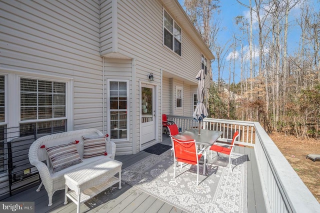 wooden deck featuring outdoor dining area