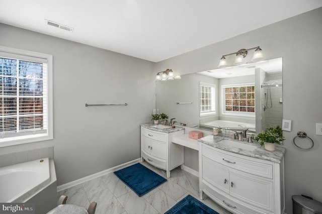 bathroom featuring marble finish floor, visible vents, a bath, and vanity