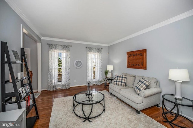 living room featuring crown molding, wood finished floors, and baseboards