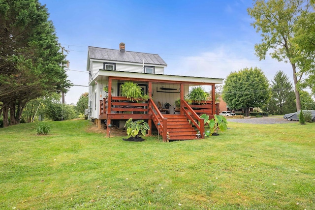 view of front of home featuring a front yard and a chimney