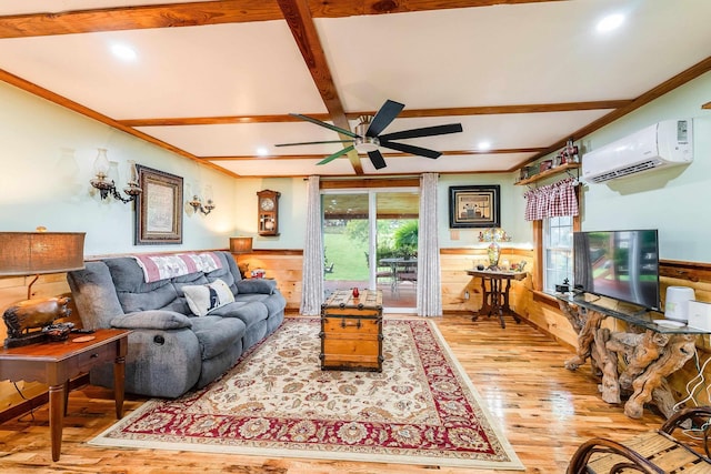 living area featuring a wainscoted wall, hardwood / wood-style floors, beamed ceiling, and a wall unit AC