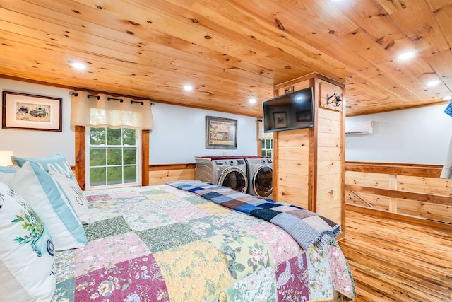 bedroom with wood finished floors, wainscoting, washing machine and clothes dryer, and wood ceiling