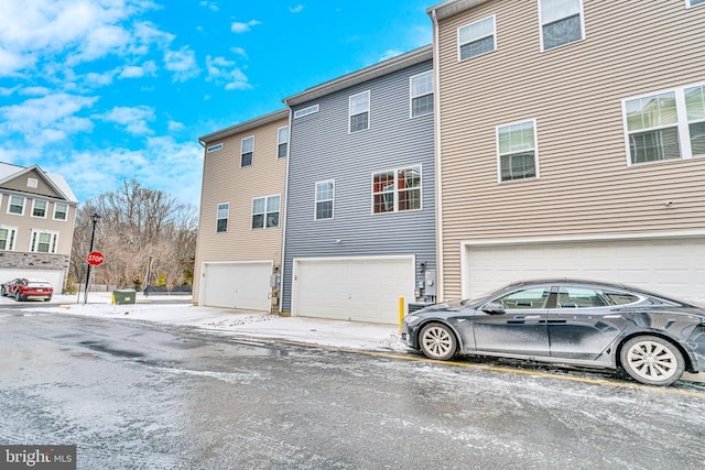 rear view of property with a garage