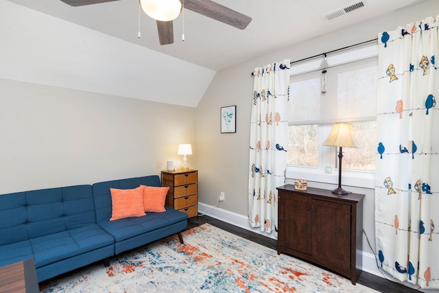 living room featuring ceiling fan, vaulted ceiling, and wood-type flooring