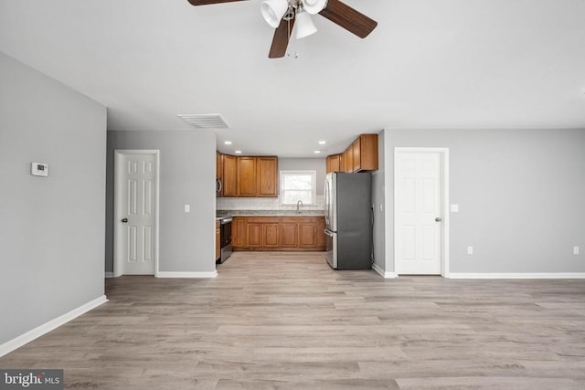 kitchen featuring open floor plan, light countertops, appliances with stainless steel finishes, and visible vents