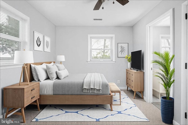 bedroom featuring carpet floors, baseboards, visible vents, and a ceiling fan