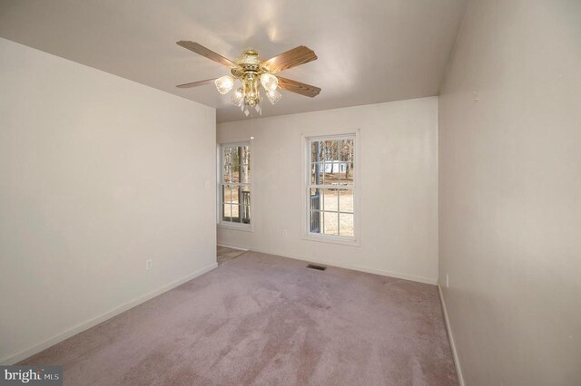 carpeted empty room featuring ceiling fan