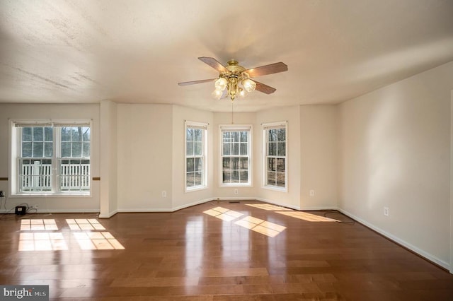 empty room featuring wood-type flooring and ceiling fan