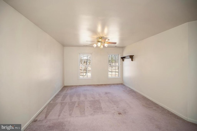 empty room with ceiling fan and light colored carpet