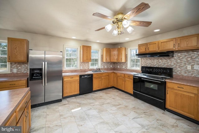 kitchen with sink, decorative backsplash, black appliances, and ceiling fan