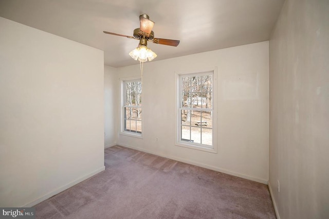 carpeted spare room with ceiling fan