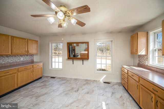 kitchen featuring a wealth of natural light and decorative backsplash