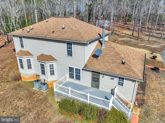 back of house featuring a wooden deck and central air condition unit