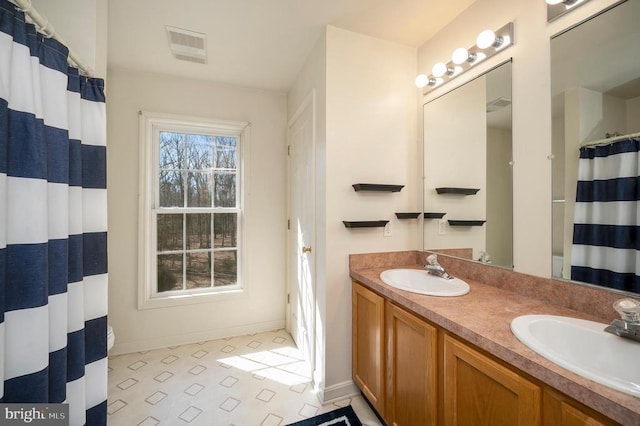 bathroom featuring vanity and curtained shower