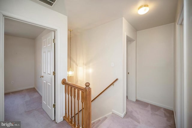 hallway featuring light carpet