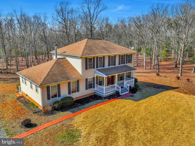 view of front of property with a front yard and covered porch