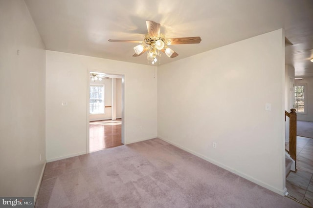 carpeted empty room featuring plenty of natural light and ceiling fan