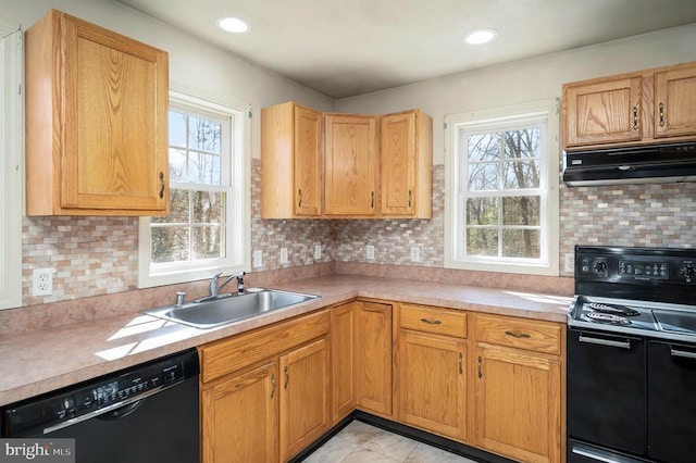 kitchen featuring sink, backsplash, and black appliances