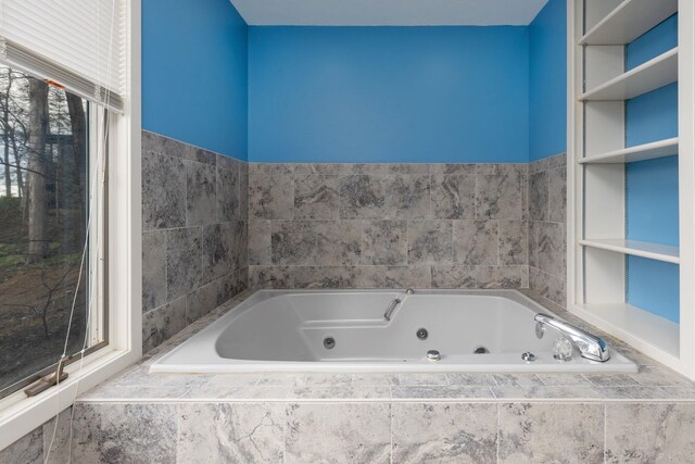 bathroom featuring a relaxing tiled tub