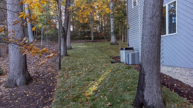 exterior space featuring a yard and central AC unit