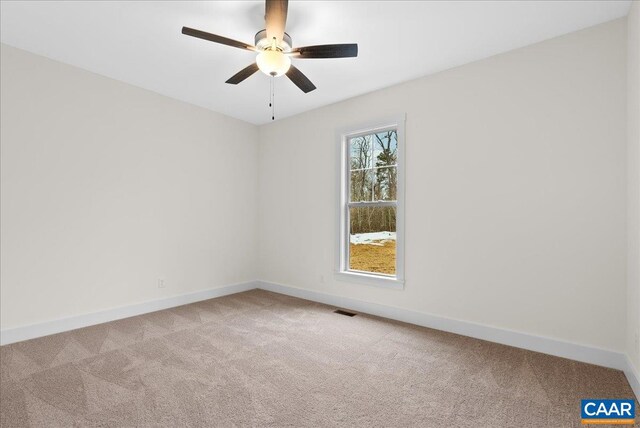 empty room with ceiling fan and light colored carpet