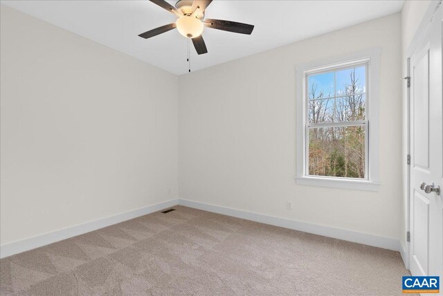 unfurnished room featuring light colored carpet and ceiling fan