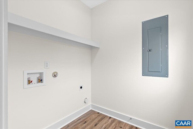 washroom with gas dryer hookup, hardwood / wood-style floors, washer hookup, electric panel, and hookup for an electric dryer