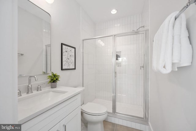 full bath with toilet, tile patterned floors, a shower stall, and vanity