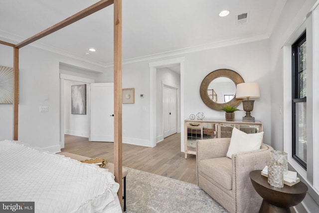 bedroom featuring recessed lighting, visible vents, crown molding, and light wood finished floors