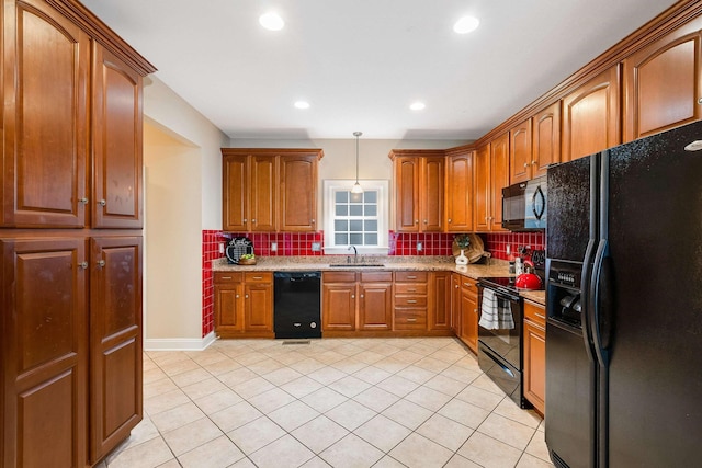 kitchen with sink, light tile patterned floors, black appliances, decorative backsplash, and decorative light fixtures