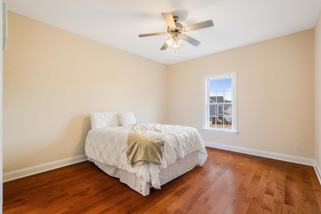 bedroom with dark wood-type flooring and ceiling fan