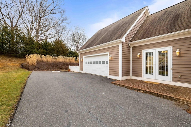 view of property exterior featuring french doors and a garage