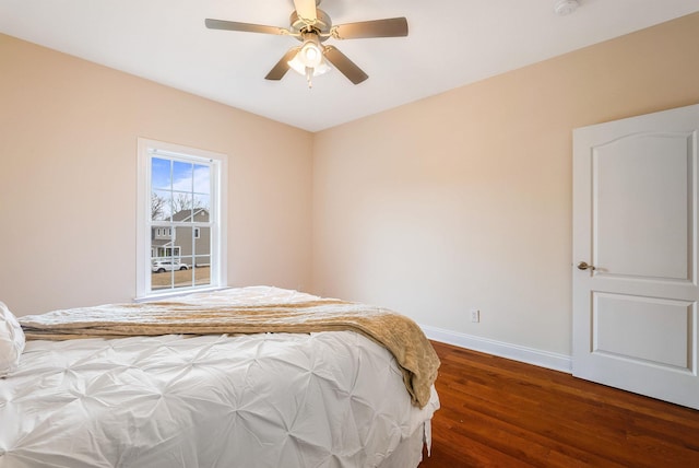 bedroom with dark hardwood / wood-style floors and ceiling fan