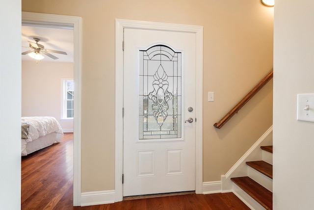 foyer entrance featuring dark wood-type flooring and ceiling fan