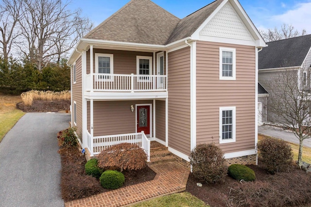 view of front of property with a porch and a balcony