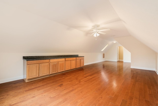 bonus room featuring ceiling fan, lofted ceiling, and wood-type flooring