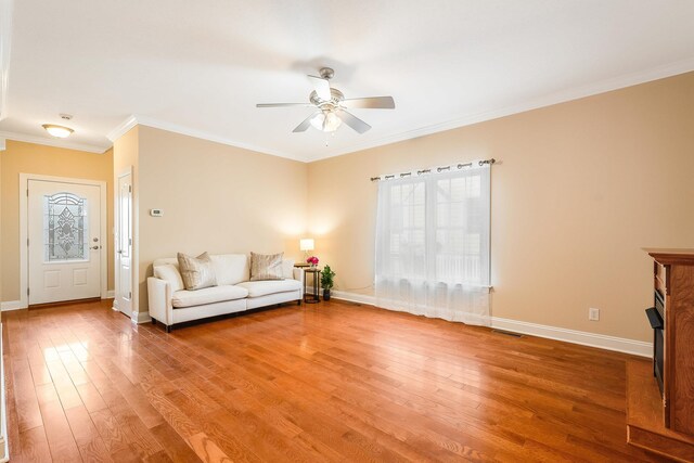 living room featuring crown molding, ceiling fan, sink, and light hardwood / wood-style floors