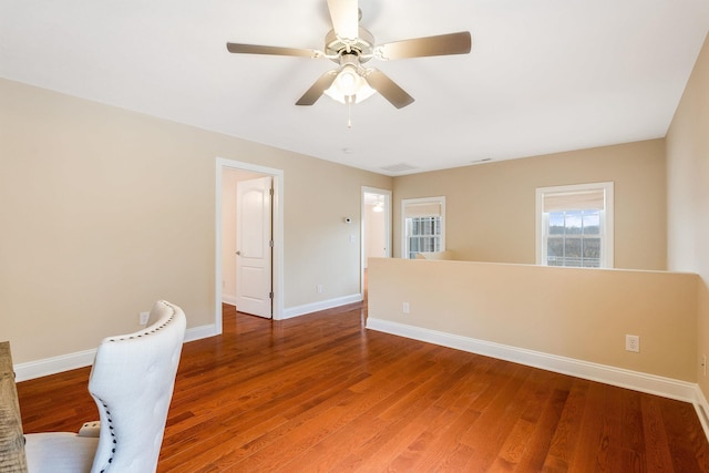 spare room with hardwood / wood-style floors and ceiling fan