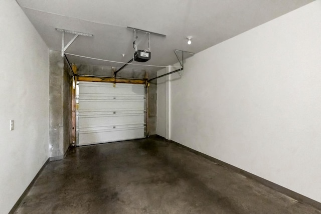 garage with baseboards and a garage door opener