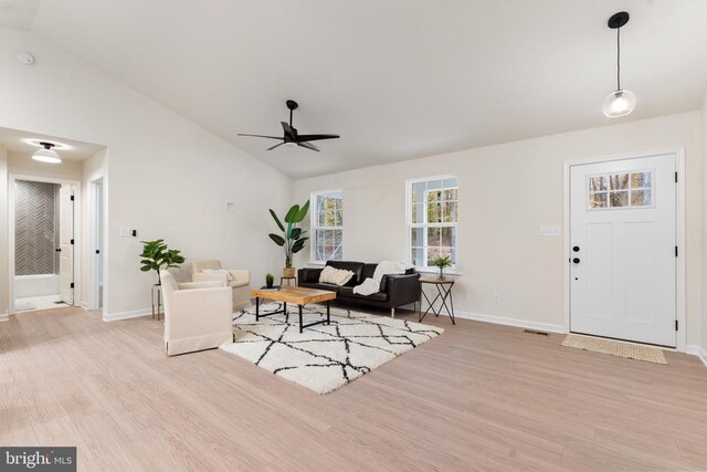 living room with lofted ceiling, light hardwood / wood-style flooring, and ceiling fan