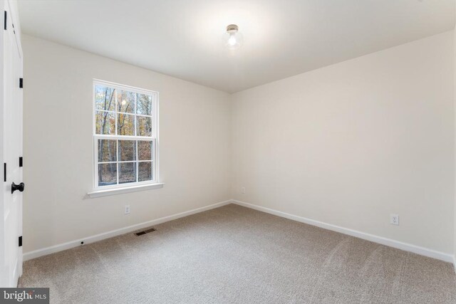 unfurnished room featuring carpet flooring