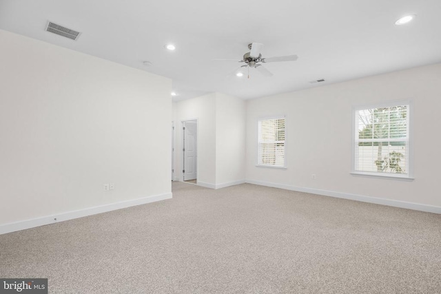 empty room with recessed lighting, a healthy amount of sunlight, and visible vents