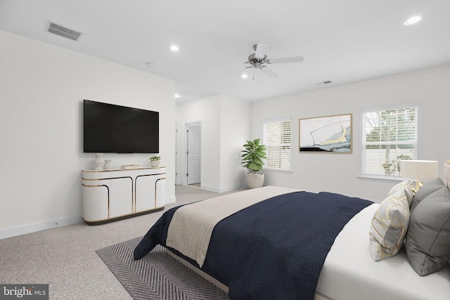 bedroom with light colored carpet, recessed lighting, and visible vents