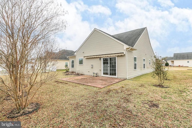 back of house with a yard and a patio area