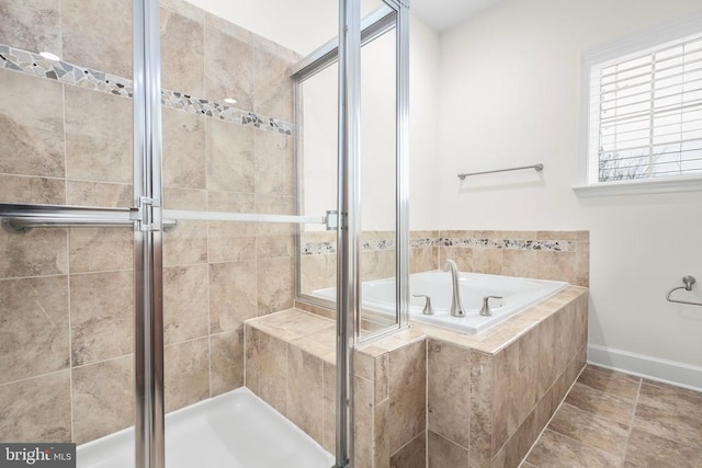 full bath with tile patterned flooring, a garden tub, baseboards, and a stall shower